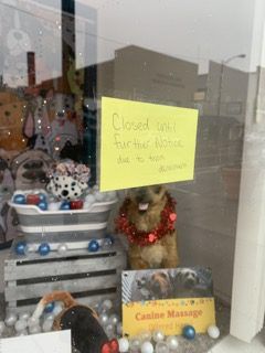 A local East Palestine, Ohio, business has a sign taped to the door stating it is closed after a train derailment cast toxic chemicals into the town.