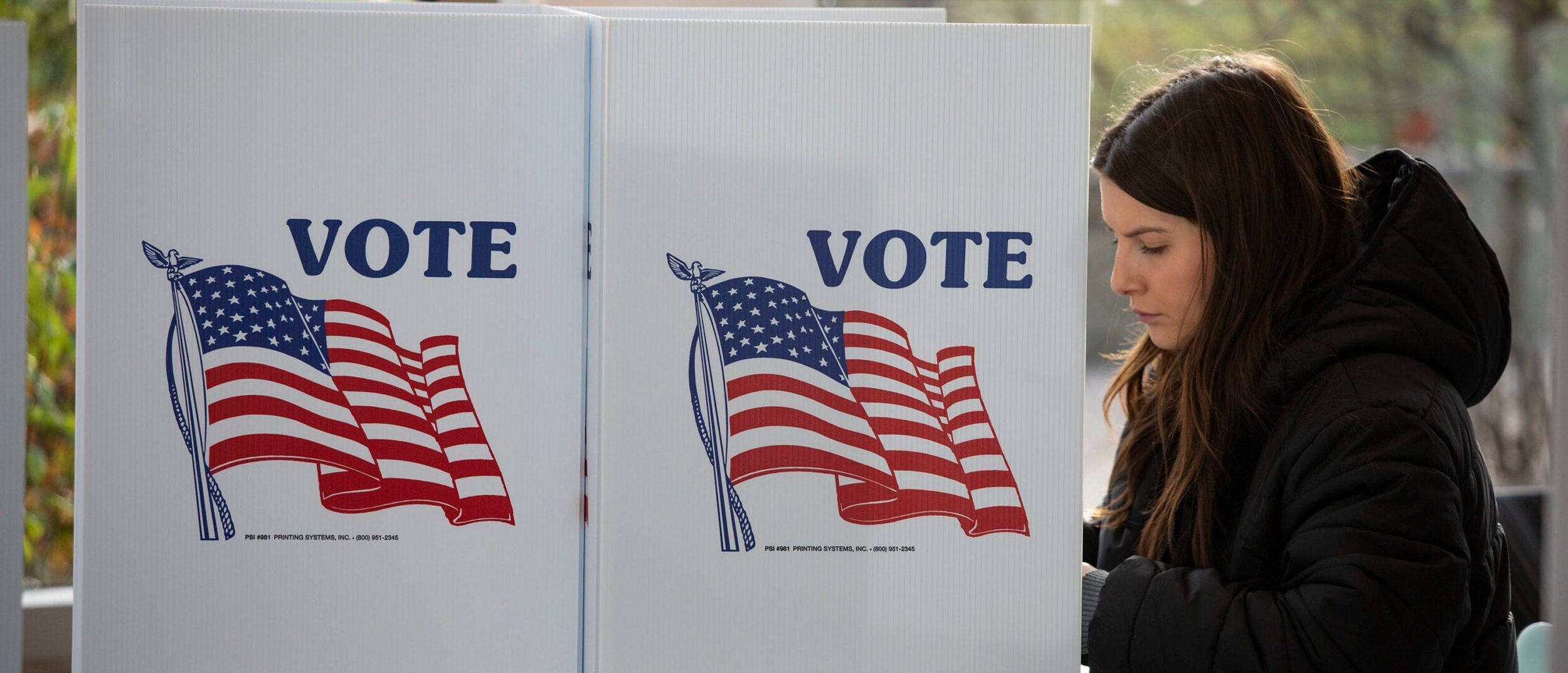 A woman votes in the 2022 midterm election on Election Day at a polling location on the Michigan State University campus on November 8, 2022 in East Lansing, Michigan.