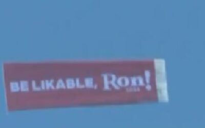 ‘Be likable, Ron!’: CNN camera catches airplane banner taking dig at DeSantis fly above his Iowa event