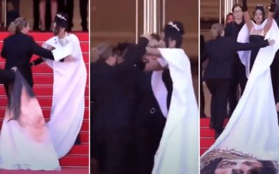 Angry actress in striking Jesus dress gets into tussle, shoves Cannes security guard for making her hide it