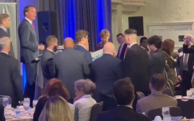 Crowd shouts down climate protesters who disrupt Youngkin as he talks about 9/11, Arlington Cemetery