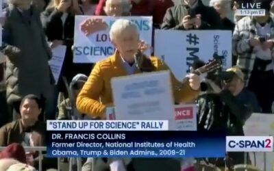 At anti-Trump Rally, former NIH director sings the same way he practices science