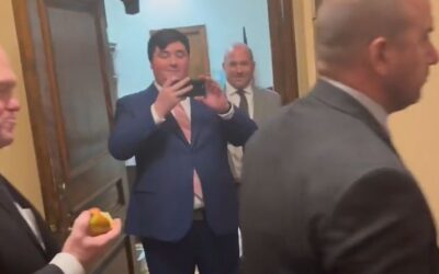 Tom Homan munches on apple, smirks as he faces protesters at state capitol