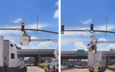 ‘He’s okay!’ Wild video shows electrical worker dangling above intersection after clipped by 18-wheeler