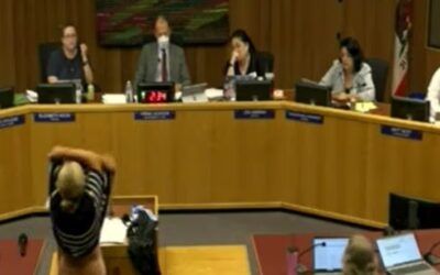 Mom stuns school board as she STRIPS during meeting to challenge trans locker room policy